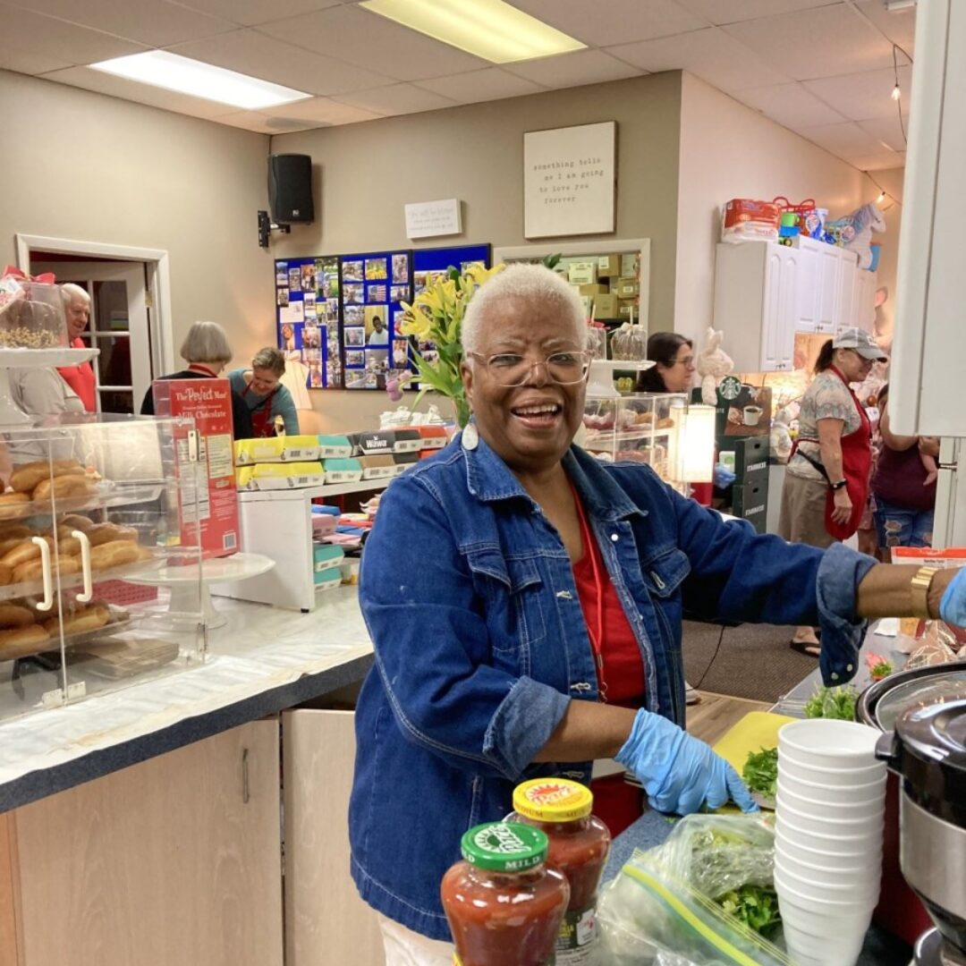 Ambassador Leona — Father & Son Love Free Food Pantry Seniors In Service Ambassador Leona prepares food at the Father & Son Love Free Food Pantry in Odessa, Florida.