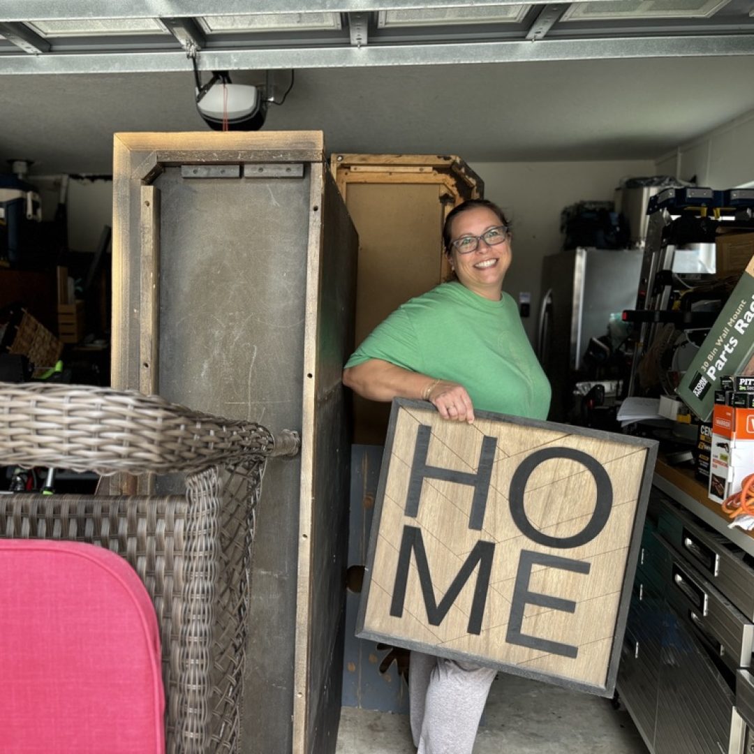Operation: Veteran Connect volunteer prepares donated furniture and a HOME sign for delivery to a senior or veteran rebuilding after hardship in Tampa Bay.